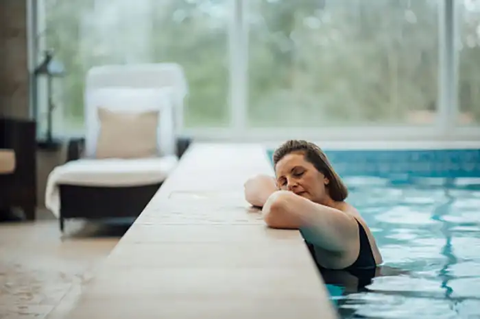 Woman resting at the side of a pool