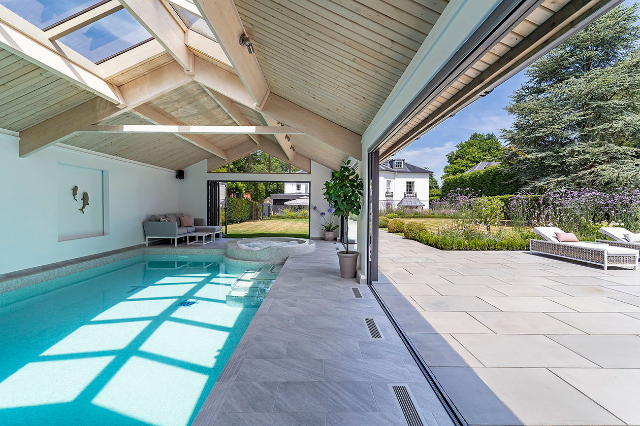 A beautiful indoor pool house with side doors fully open